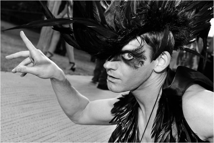 circus performer at a party in black and white