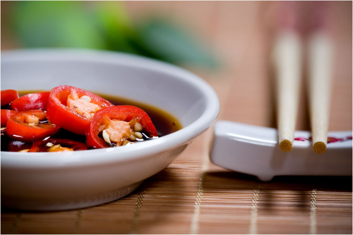 food photography of chillies and chopsticks