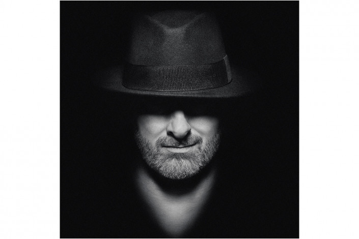 man in hat with moody lighting
